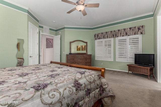 carpeted bedroom featuring ceiling fan and crown molding