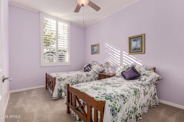 carpeted bedroom with ceiling fan and ornamental molding