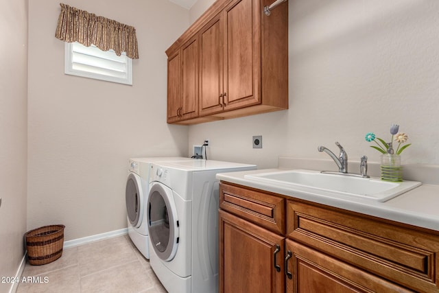 washroom with cabinets, light tile patterned floors, separate washer and dryer, and sink