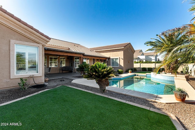 view of swimming pool with a lawn and a patio