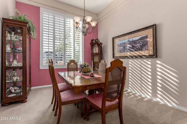 dining room featuring carpet flooring and an inviting chandelier