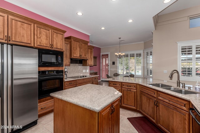 kitchen featuring black appliances, a center island, ornamental molding, and sink