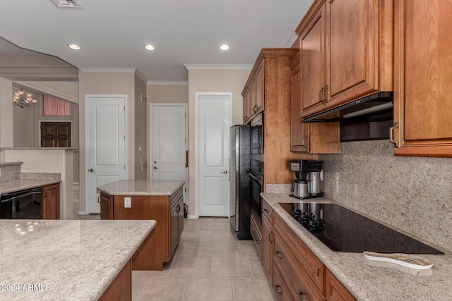 kitchen with tasteful backsplash, light stone counters, black appliances, light tile patterned floors, and a kitchen island