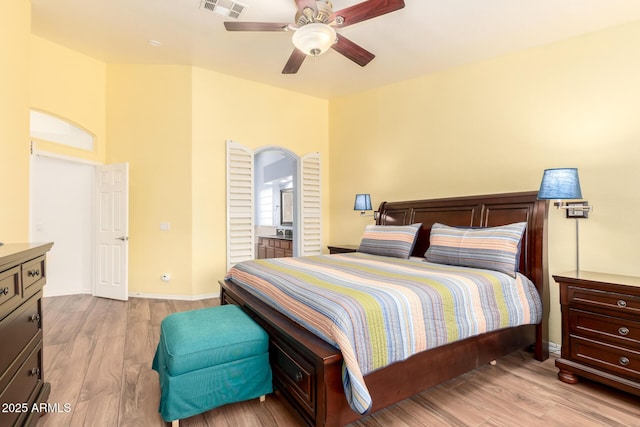 bedroom featuring light wood-type flooring, visible vents, and a ceiling fan