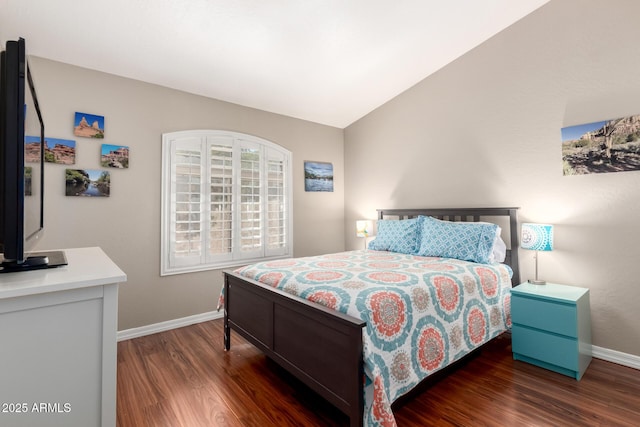 bedroom featuring vaulted ceiling, baseboards, and wood finished floors