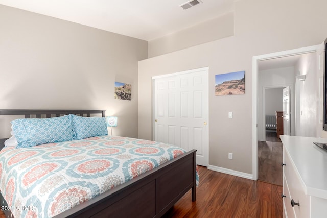 bedroom featuring visible vents, dark wood finished floors, and baseboards