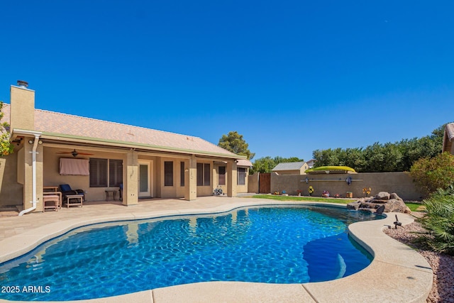 view of pool with ceiling fan, a patio area, a fenced backyard, and a fenced in pool