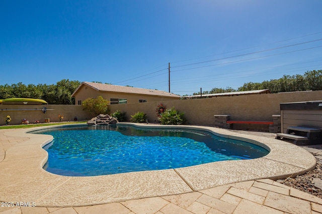 view of swimming pool with a fenced in pool, a fenced backyard, and a patio