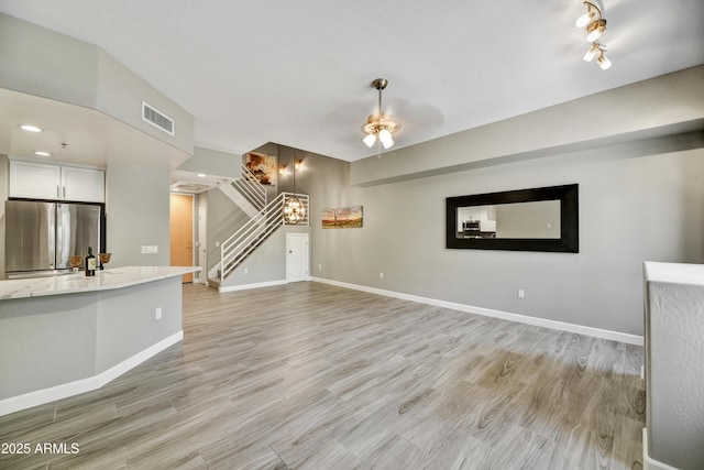 16 W Encanto Blvd Unit 22, Phoenix, AZ 85003 - unfurnished living room featuring stairway, light wood finished floors, baseboards, and a ceiling fan