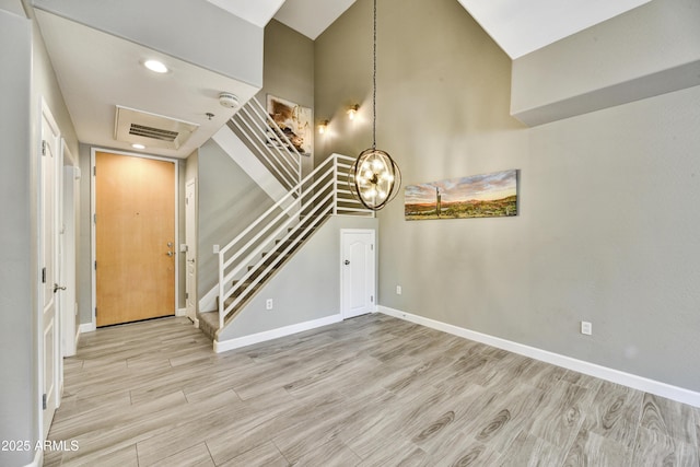 16 W Encanto Blvd Unit 22, Phoenix, AZ 85003 - foyer entrance featuring a chandelier, stairway, wood finished floors, and baseboards