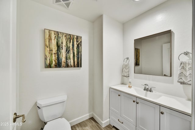 16 W Encanto Blvd Unit 22, Phoenix, AZ 85003 - bathroom with toilet, vanity, wood finished floors, and baseboards