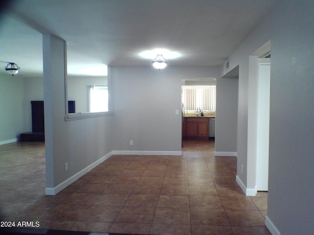 hall featuring dark tile patterned floors