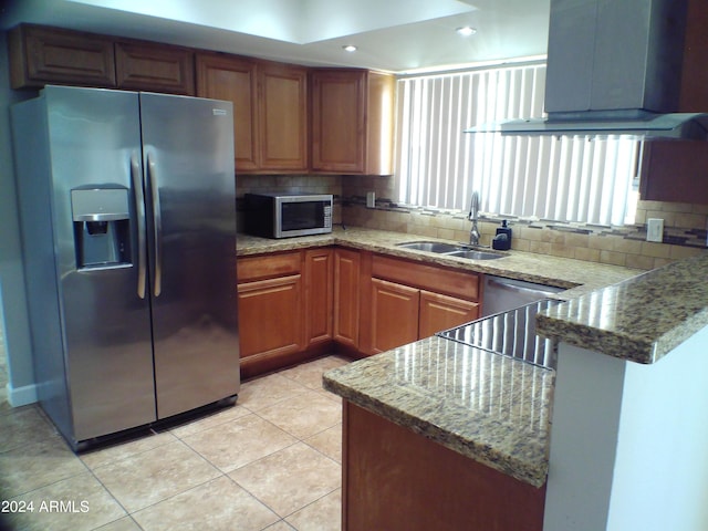 kitchen featuring sink, light stone countertops, and stainless steel appliances