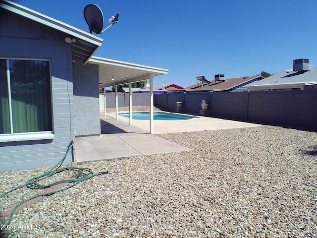 view of yard featuring a fenced in pool and a patio