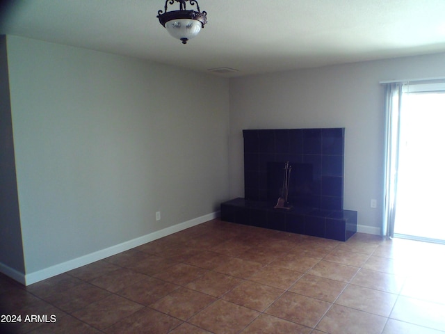 unfurnished living room with tile patterned floors and a fireplace