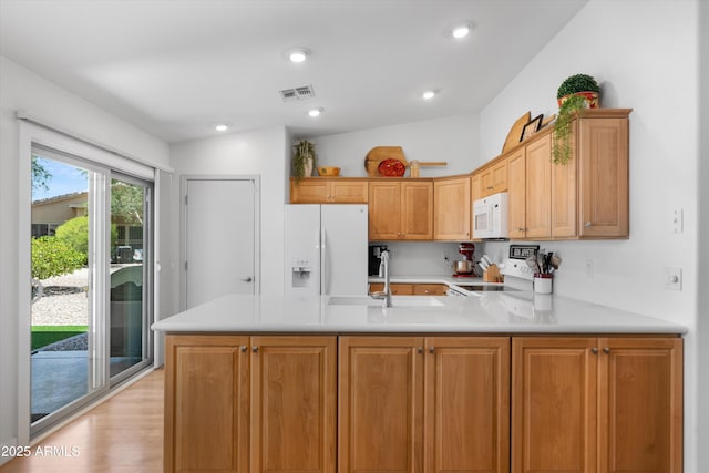 5024 S Citrus Ct, Gilbert, AZ 85298 - kitchen with white appliances, a peninsula, light countertops, light wood-style floors, and recessed lighting