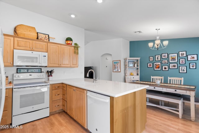 5024 S Citrus Ct, Gilbert, AZ 85298 - kitchen with white appliances, light brown cabinetry, light wood finished floors, a peninsula, and arched walkways