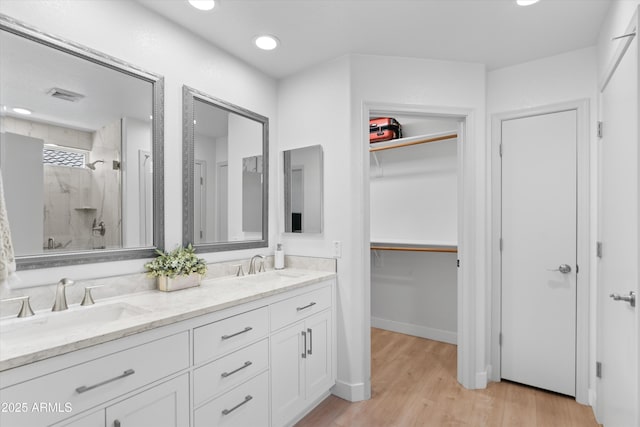 5024 S Citrus Ct, Gilbert, AZ 85298 - full bath with a shower stall, double vanity, wood finished floors, a spacious closet, and recessed lighting