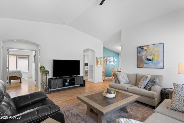 5024 S Citrus Ct, Gilbert, AZ 85298 - living area with arched walkways, lofted ceiling, light wood-style floors, and a ceiling fan