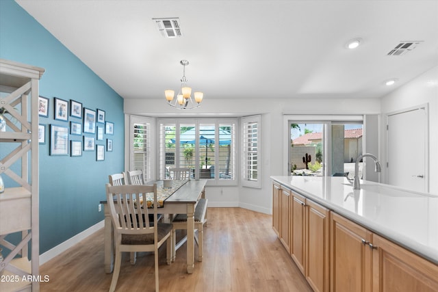 5024 S Citrus Ct, Gilbert, AZ 85298 - dining space featuring a chandelier, light wood finished floors, and plenty of natural light