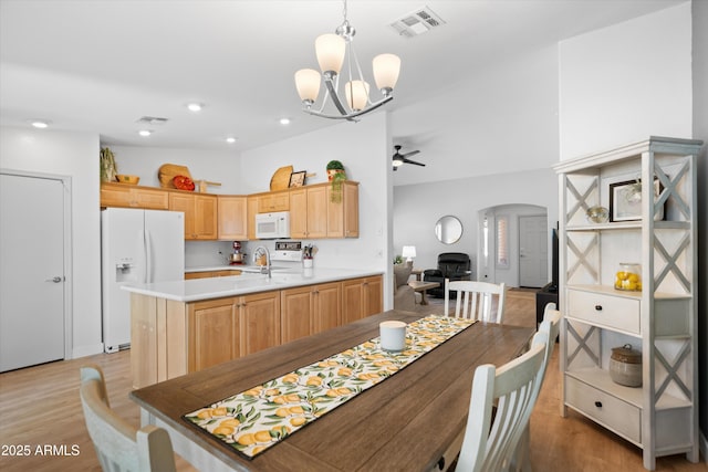 5024 S Citrus Ct, Gilbert, AZ 85298 - dining space with arched walkways, a chandelier, light wood finished floors, a ceiling fan, and recessed lighting