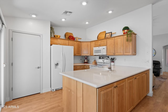5024 S Citrus Ct, Gilbert, AZ 85298 - kitchen featuring white appliances, light wood-type flooring, a peninsula, light countertops, and recessed lighting