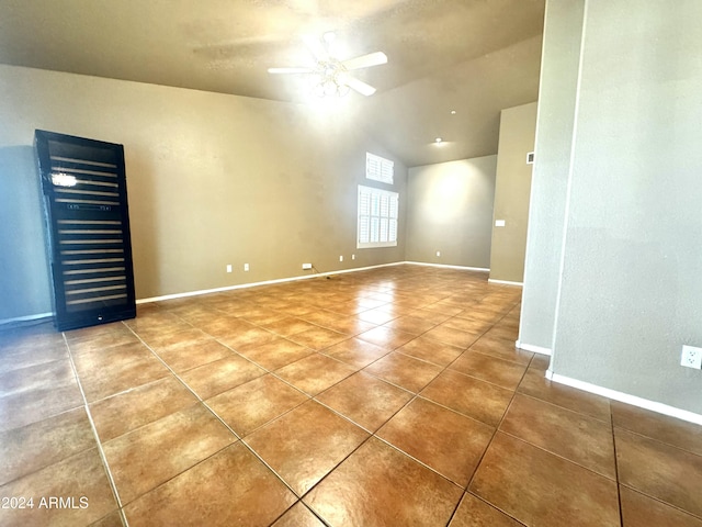 spare room with tile patterned flooring, ceiling fan, and vaulted ceiling