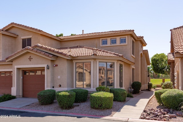 mediterranean / spanish home featuring a garage