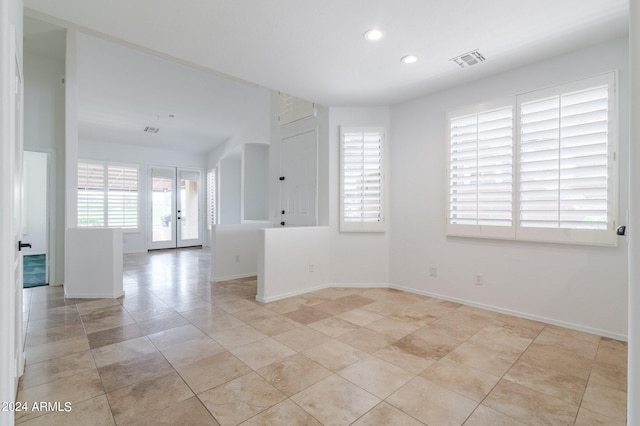 spare room featuring french doors