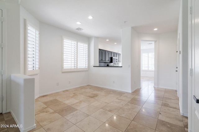 unfurnished living room featuring light tile patterned floors