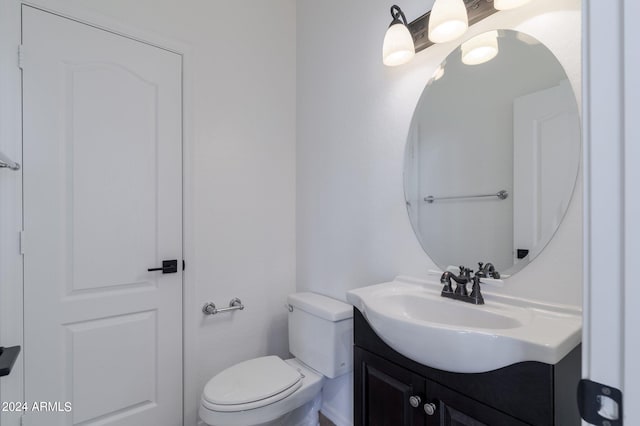 bathroom featuring toilet and vanity