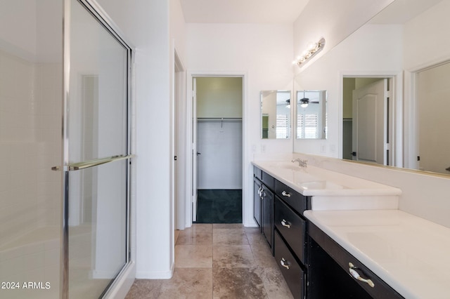 bathroom featuring ceiling fan, vanity, and a shower with door