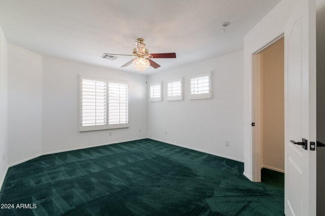 carpeted spare room with ceiling fan