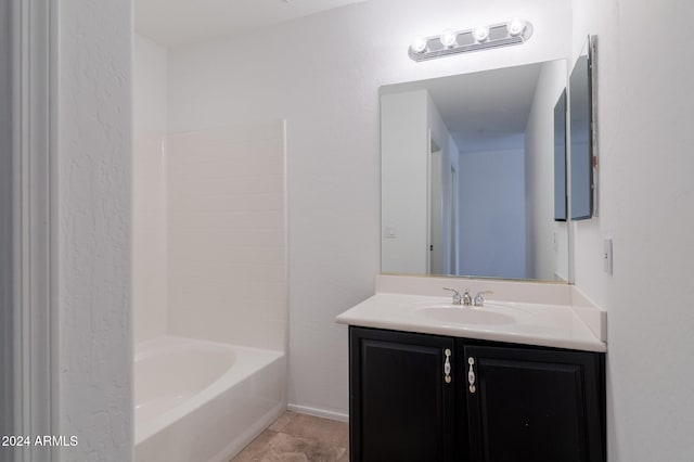 bathroom featuring tub / shower combination, vanity, and tile patterned flooring