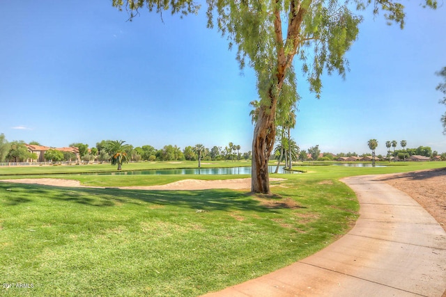 view of property's community featuring a yard and a water view