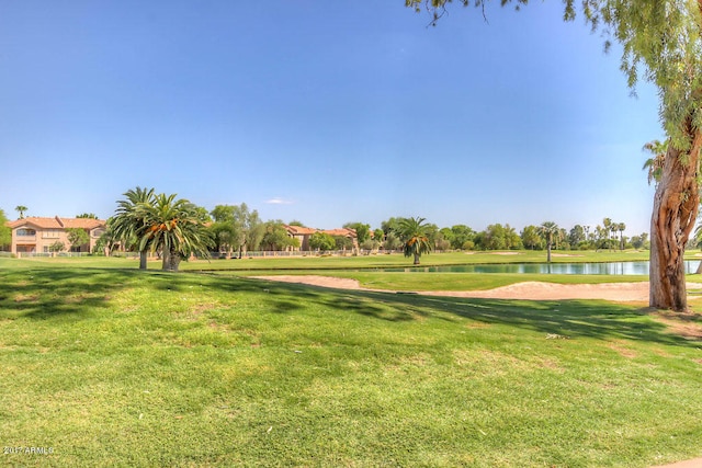 surrounding community featuring a yard and a water view