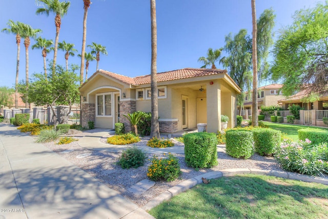 mediterranean / spanish-style house with a front yard