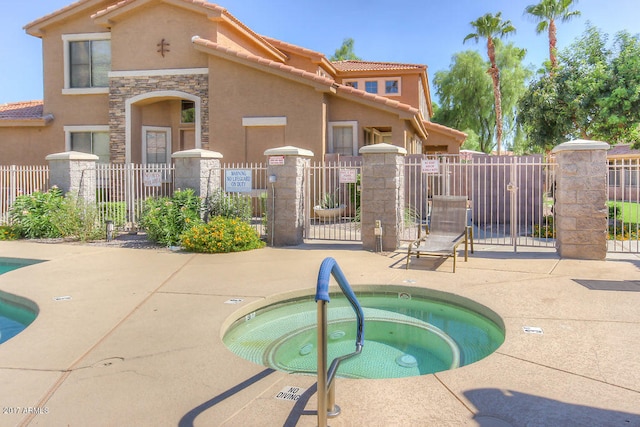 view of pool with a patio and a hot tub