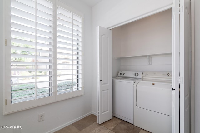 laundry room with separate washer and dryer and light tile patterned floors