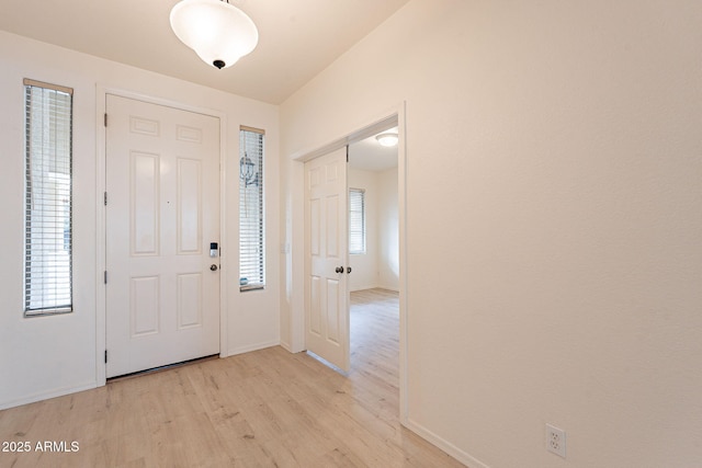 entryway with plenty of natural light and light hardwood / wood-style flooring