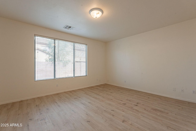 spare room featuring light wood-type flooring