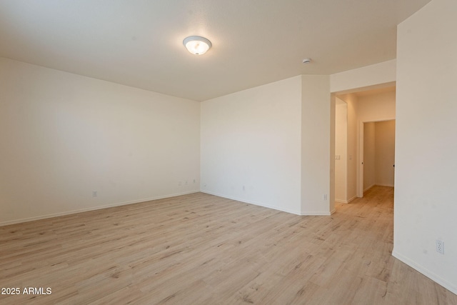 spare room with light hardwood / wood-style flooring