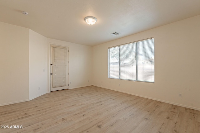 spare room featuring light hardwood / wood-style flooring