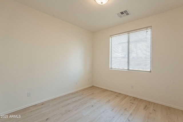 unfurnished room with light wood-type flooring