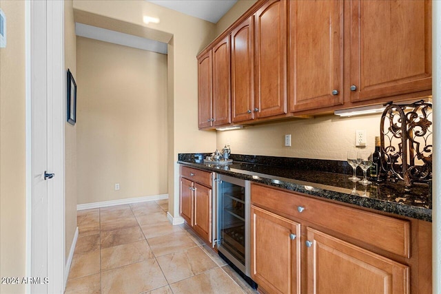 kitchen featuring wine cooler and dark stone countertops