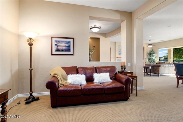 carpeted living room featuring ceiling fan