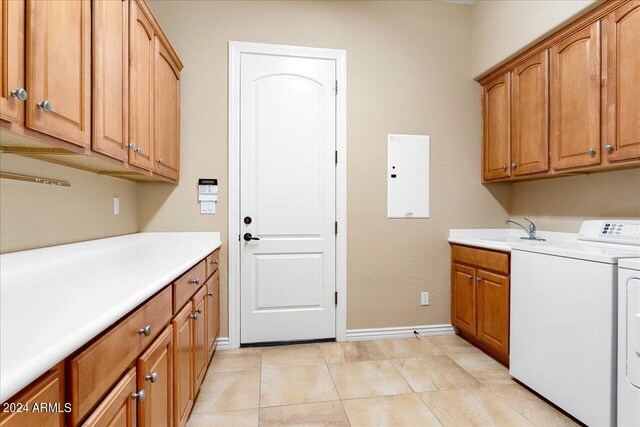 clothes washing area featuring light tile patterned flooring, cabinets, sink, and washing machine and clothes dryer