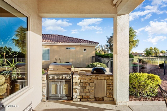 view of patio with area for grilling and a grill