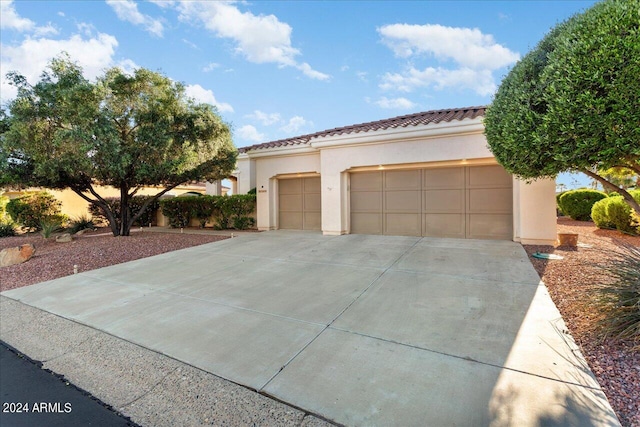 mediterranean / spanish-style home with a garage