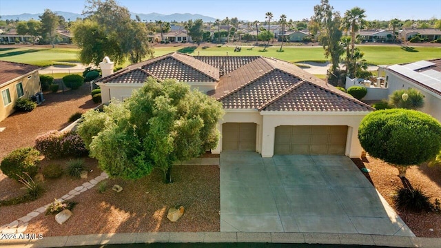 view of front of property with a mountain view and a garage